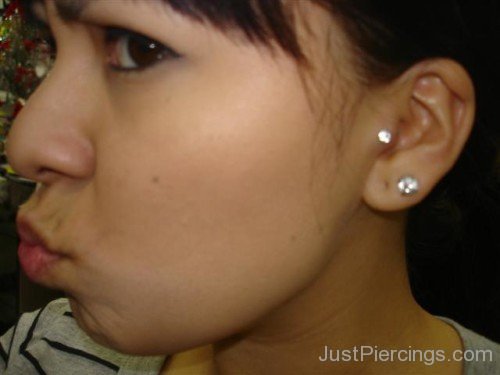 Lobe and Silver Tragus Piercing