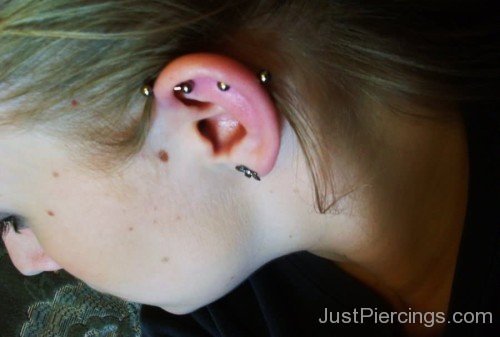 Girl Have Lobe And Scaffold Piercing