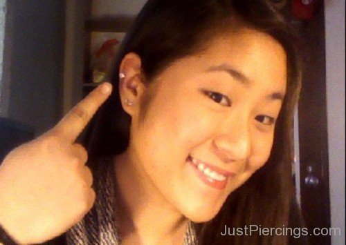 Girl Showing Her Lobe And Helix Piercing-JP123